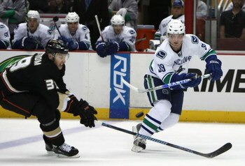 ANAHEIM, CA - SEPTEMBER 28:  Cody Hodgson #39 of the Vancouver Canucks passes the puck under pressure from Joakim Lindstrom #39 of the Anaheim Ducks during the preseason NHL game at Honda Center on September 28, 2008 in Anaheim, California.  (Photo by Chr