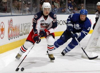 TORONTO - OCTOBER 5: Jonas Frogren #24 of the Toronto Maple Leafs defends against Nikita Filatov #28 of the Columbus Blue Jackets during their pre season NHL game at the Air Canada Centre October 5, 2008 in Toronto, Ontario.(Photo By Dave Sandford/Getty I