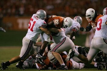 AUSTIN, TX - SEPTEMBER 09:   Running back Selvin Young #22 of the Texas Longhorns is tackled by Ross Homan #51 of the Ohio State Buckeyes on September 9, 2006 at Texas Memorial Stadium in Austin, Texas.  (Photo by Ronald Martinez/Getty Images)