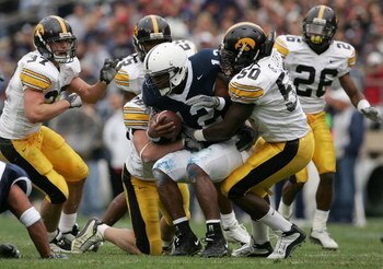 STATE COLLEGE, PA - OCTOBER 23:  Quarterback Michael Robinson #12 of the Penn State Nittnay Lions is tackled by George Lewis #50 and the Iowa Hawkeyes defense as Iowa defeated Penn State 6-4 during NCAA football at Beaver Stadium on October 23, 2004 in St