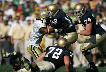SOUTH BEND, IN - SEPTEMBER 01: Evan Sharpley #13 of the Notre Dame Fighting Irish is sacked by Morgan Burnett #1 of the Georgia Tech Yellow Jackets as teammates Paul Duncan #72 and Sam Young #74 watch on September 1, 2007 at Notre Dame Stadium in South Be