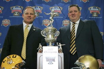 NEW ORLEANS - JANUARY 2:  Head coach Les Miles of Lousiana State University (L) and head coach Charlie Weis of the University of Notre Dame (R) pose with the Allstate Sugar Bowl trophy during a news conference January 2, 2007 in New Orleans, Louisiana.  (