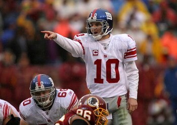 LANDOVER, MD - NOVEMBER 30:  Eli Manning #10 of the New York Giants runs points to his team against the Washington Redskins during their game at FedEx Field on November 30, 2008 in Landover, Maryland.  (Photo by Streeter Lecka/Getty Images)