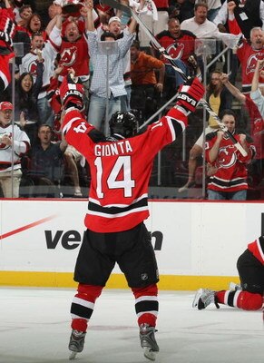 NEWARK, NJ - APRIL 28: Brian Gionta #14 of the New Jersey Devils celebrates a goal by Brian Rolston #12 (not shown) against the Carolina Hurricanes during Game Seven of the Eastern Conference Semifinal Round of the 2009 Stanley Cup Playoffs at the Prudent