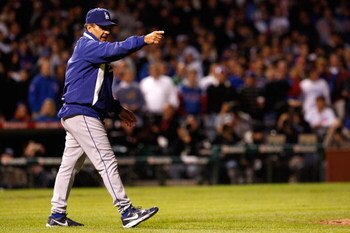 CHICAGO - OCTOBER 02:  Manager Joe Torre #6 of the Los Angeles Dodgers makes the call to the bullpen to relieve starting pitcher Chad Billingsley in the bottom of the seventh inning with Cory Wade against the Chicago Cubs in Game Two of the NLDS during th