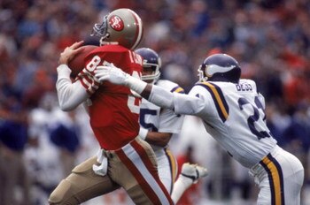 SAN FRANCISCO - DECEMBER 8:  Wide receiver Dwight Clark #87 of the San Francisco 49ers catches a pass against defensive back Rufus Bess #21 of the Minnesota Vikings during a game at Candlestick Park on December 8, 1984 in San Francisco, California.  The 4