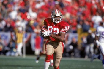 SAN FRANCISCO - JANUARY 15:  Wide receiver John Taylor #82 of the San Francisco 49ers runs with the ball during the 1993 NFC Championship game against the New York Giants at Candlestick Park on January 15, 1994 in San Francisco, California.  The 49ers won