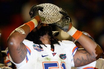 MIAMI - JANUARY 08:  Brandon Spikes #51 of the Florida Gators celebrate with the trophy after defeating the Oklahoma Sooners in the FedEx BCS National Championship Game at Dolphin Stadium on January 8, 2009 in Miami, Florida. The Gators won the game by a 