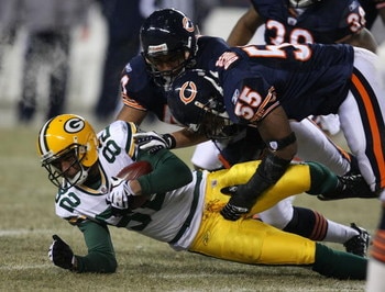 CHICAGO - DECEMBER 22: Lance Briggs #55 and Kevin Payne #44 of the Chicago Bears bring down Ruvell Martin #82 of the Green Bay Packers on December 22, 2008 at Soldier Field in Chicago, Illinois.  The Bears defeated the Packers 20-17 in overtime. (Photo by