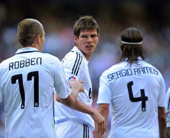 MADRID, SPAIN - MARCH 22:  Klaas Jan Huntelaar of Real Madrid celebrates with Arjen Robben and Sergio Ramos after scoring Real's second goal during the La Liga match between Real Madrid and UD Almeria at the Santiago Bernabeu stadium on March 22, 2009 in 