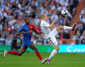 MADRID, SPAIN - MAY 02:  Arjen Robben (R) of Real Madrid duels for the ball with Eric Abidal of Barcelona during the La Liga match between Real Madrid and Barcelona at the Santiago Bernabeu Stadium on May 2, 2009 in Madrid, Spain.  (Photo by Jasper Juinen