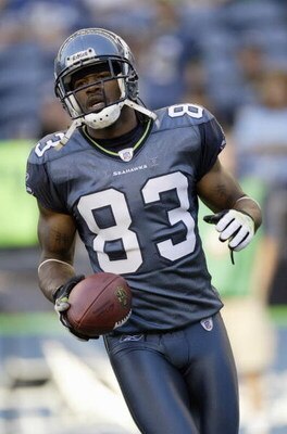 SEATTLE - AUGUST 12:  Peter Warrick #83 of the Seattle Seahawks carries the ball before the preseason game against the Dallas Cowboys on August 12, 2006 at Qwest Field in Seattle Washington. (Photo by Otto Greule Jr/Getty Images) 