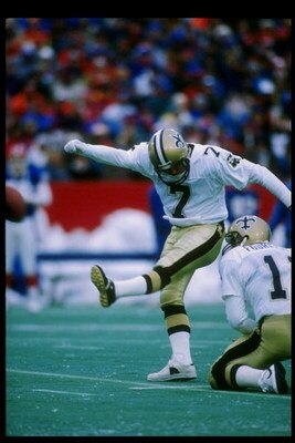 10 Dec 1989: Kicker Morten Andersen of the New Orleans Saints (left) kicks the ball held by quarterback John Fourcade during a game against the Buffalo Bills at Rich Stadium in Orchard Park, New York. The Saints won the game 22-19.