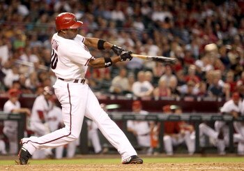 PHOENIX - JULY 29: Justin Upton #10 of the Arizona Diamondbacks hits an RBI single against the Philadelphia Phillies during the eighth inning of the Major League Baseball game at Chase Field July 29, 2009 in Phoenix, Arizona.  (Photo by Christian Petersen