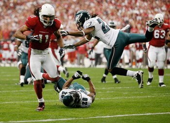 GLENDALE, AZ - JANUARY 18:  Larry Fitzgerald #11 of the Arizona Cardinals runs past safety Brian Dawkins #20 and cornerback Asante Samuel #22 of the Philadelphia Eagles into the endzone for a touchdown during the NFC championship game on January 18, 2009 