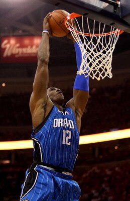 CLEVELAND - MAY 20:  Dwight Howard #12 of the Orlando Magic dunks the ball against the Cleveland Cavaliers in Game One of the Eastern Conference Finals during the 2009 Playoffs at Quicken Loans Arena on May 20, 2009 in Cleveland, Ohio. NOTE TO USER: User 
