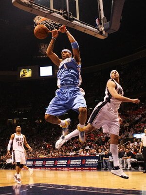 EAST RUTHERFORD, NJ - MARCH 21:  Kenyon Martin #4 of the Denver Nuggets dunks the ball as Josh Boone #2 of the New Jersey Nets defends during their game on March 21, 2008 at the Izod Arena in East Rutherford, New Jersey.  Photo By Al Bello/Getty Images.  