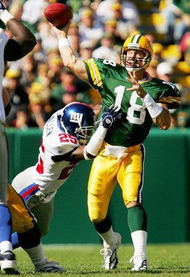 GREEN BAY, WI - OCTOBER 3:  Doug Pederson #18 of the Green Bay Packers throws under pressure by Will Allen #25 of the New York Giants October 3, 2004 at Lambeau Field in Green Bay, Wisconsin. The Giants defeated the Packers 14-7.  (Photo by Matthew Stockm