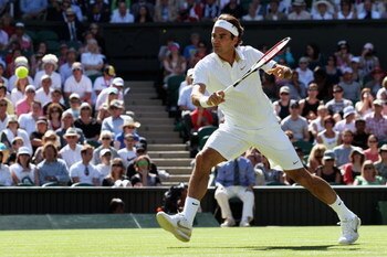 WIMBLEDON, ENGLAND - JUNE 24:  Roger Federer of Switzerland plays a backhand volley during the men's singles second round match against Guillermo Garcia-Lopez of Spain on Day Three of the Wimbledon Lawn Tennis Championships at the All England Lawn Tennis 