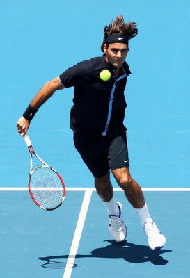 MELBOURNE, AUSTRALIA - JANUARY 14:  Roger Federer of Switzerland plays a backhand drop shot during his match against Carlos Moya of Spain during day one of the AAMI Classic at the Kooyong Lawn Tennis Club on January 14, 2009 in Melbourne, Australia.  (Pho