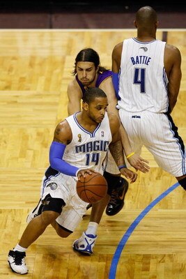 ORLANDO, FL - JUNE 14:  Jameer Nelson #14 of the Orlando Magic drives past Sasha Vujacic #18 of the Los Angeles Lakers as teammate Tony Battie #4 of the Magic sets a screen in Game Five of the 2009 NBA Finals on June 14, 2009 at Amway Arena in Orlando, Fl