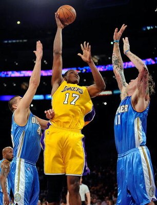 LOS ANGELES, CA - MAY 27:  Andrew Bynum #17 of the Los Angeles Lakers goes up for a shot over Linas Kleiza #43 and Chris Andersen #11 of the Denver Nuggets in the second half of Game Five of the Western Conference Finals during the 2009 NBA Playoffs at St