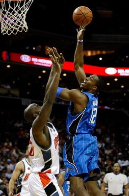 CHARLOTTE, NC - FEBRUARY 20:  Dwight Howard #12 of the Orlando Magic shoots the ball over Emeka Okafor #50 of the Charlotte Bobcats during their game at Time Warner Cable Arena on February 20, 2009 in Charlotte, North Carolina. NOTE TO USER: User expressl