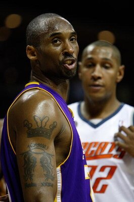 CHARLOTTE, NC - MARCH 31:  Kobe Bryant #24 of the Los Angeles Lakers reacts to a call as Boris Diaw #32 of the Charlotte Bobcats watches on during their game at Time Warner Cable Arena on March 31, 2009 in Charlotte, North Carolina.  NOTE TO USER: User ex