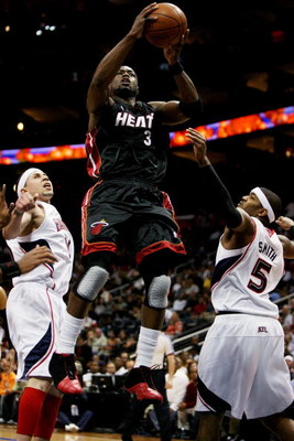 ATLANTA - APRIL 22: Dwyane Wade #3 of the Miami Heat drives between Mike Bibby #10 and Josh Smith #5 of the Atlanta Hawks during Game Two of the Eastern Conference Quarterfinals at Philips Arena on April 22, 2009 in Atlanta, Georgia. NOTE TO USER: User e