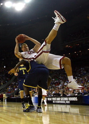 KANSAS CITY, MO - MARCH 21: Blake Griffin #23 of the Oklahoma Sooners falls on the back of Manny Harris #3 of the Michigan Wolverines during the second round of the NCAA Division I Men's Basketball Tournament at the Sprint Center on March 21, 2009 in Kan