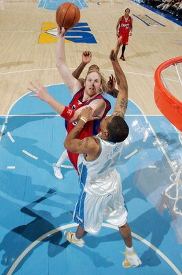 DENVER - APRIL 29:  Chris Kaman #35 of the Los Angeles Clippers shoots over Marcus Camby #23 of the Denver Nuggets in game four of the Western Conference Quarterfinals during the 2006 NBA Playoffs on April 29, 2006 at the Pepsi Center in Denver, Colorado.
