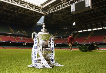 CARDIFF - MAY 3:  The FA Cup trophy sits proudly on the pitch as a groundsman makes final preparations for the final of the FA Cup during the AXA FA Cup Preview held at The Millennium Stadium in Cardiff, Wales on May 3, 2002. (Photo by: Stu Forster/Getty 