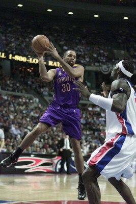 AUBURN HILLS - APRIL 21:  Dell Curry #30 of the Toronto Raptors passes over Ben Wallace #3 of the Detroit Pistons during game 1 of the Eastern Conference Quarterfinals during the 2002 NBA Playoffs at the Palace in Auburn Hills in Auburn Hills, Michigan on
