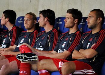BARCELONA, SPAIN - AUGUST 02:  Xabi Alonso (2nd R) of Liverpool sits on the bench with his teammates prior to the pre-season friendly match between Espanyol and Liverpool at the Nuevo Estadio de Cornella-El Prat on August 2, 2009 in Barcelona, Spain.  (Ph