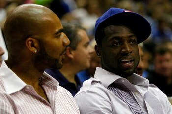 ORLANDO, FL - JUNE 11:  US Olympic teammates Carlos Boozer of the Utah Jazz and Dwyane Wade of the Miami Heat sit together at Game Four of the 2009 NBA Finals between the Los Angeles Lakers and the Orlando Magic on June 11, 2009 at Amway Arena in Orlando,