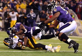 BALTIMORE - DECEMBER 14:  Santonio Holmes #10 of the Pittsburgh Steelers makes a catch with both feet in the endzone for a late fourth quarter game winning touchdown as Ed Reed #20 of the Baltimore Ravens defends on December 14, 2008 at M&T Bank Stadium i