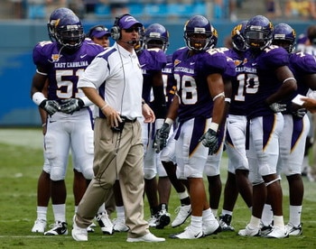 CHARLOTTE, NC - AUGUST 30:  Head coach Skip Holtz of the East Carolina Pirates stands with his team against the Virginia Tech Hokies on August 30, 2008 at Bank of America Stadium in Charlotte, North Carolina.  (Photo by Streeter Lecka/Getty Images)