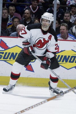EAST RUTHERFORD, NJ - FEBRUARY 25:  Scott Niedermayer #27 of the New Jersey Devils looks to pass against the New York Rangers at Continental Airlines Arena on Febuary 25, 2003 in East Rutherford, New Jersey. The Rangers and the Devils skated to a 3-3 tie.
