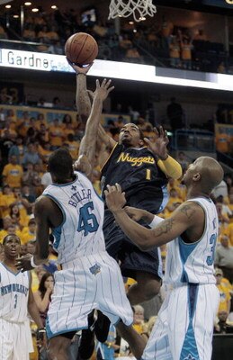NEW ORLEANS - APRIL 25:  J.R. Smith #1 of the Denver Nuggets goes to the basket over Rasual Butler #45 and David West #30 of the New Orleans Hornets during Game Three of the Western Conference Quarterfinals during the 2009 NBA Playoffs at New Orleans Aren