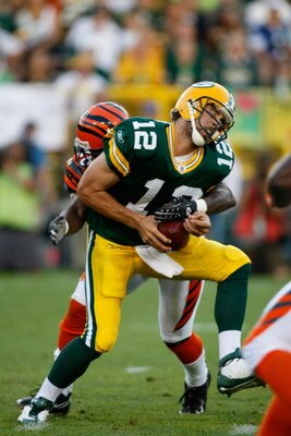 GREEN BAY, WI - AUGUST 11: Quarterback Aaron Rogers #12 of the Green Bay Packers is sacked by a defender in the 1st quarter against the Cincinnati Bengals at the Lambeau Field on August 11, 2008 in Green Bay, Wisconsin. (Photo by Scott Boehm/Getty Images)