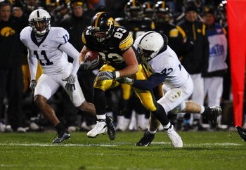 IOWA CITY, IA - NOVEMBER 8:  Tony Davis #11 and his teammate Josh Hull #43 of the Penn State Nittany Lions tackle tight end Brandon Myers #83 of the Iowa Hawkeyes as he rushes for yards in the fourth quarter of play at Kinnick Stadium on November 8, 2008 