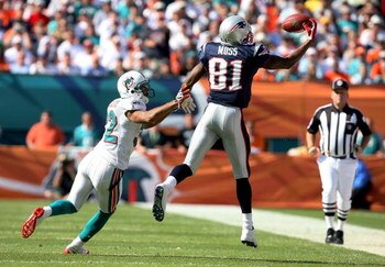 MIAMI - NOVEMBER 23: Wide receiver Randy Moss #81 of the New England Patriots pulls in a one-handed catch over cornerback Jason Allen #32 of the Miami Dolphins at Dolphin Stadium on November 23, 2008 in Miami, Florida.  (Photo by Doug Benc/Getty Images)