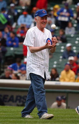 CHICAGO - AUGUST 12: Actor John Mahoney flips the ball after throwing out a ceremonial first pitch before a game between the Chicago Cubs and the San Diego Padres on August 12, 2004 at Wrigley Field in Chicago, Illinois. The Padres defeated the Cubs 5-4