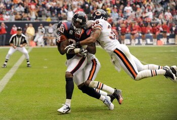 HOUSTON - DECEMBER 28:  Andre Johnson #80 of the Houston Texans runs in for a touchdown after his catch as he is tackled by Danieal Manning #38 and Charles Tillman #33 of the Chicago Bears to trail 7-10 during the first half at the Reliant Stadium Decembe