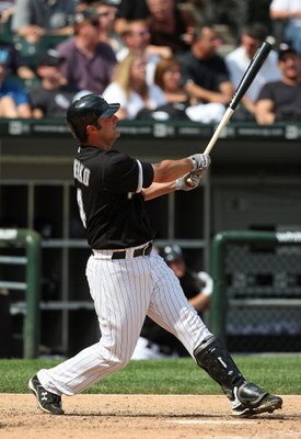 CHICAGO - JUNE 08: Paul Konerko #14 of the Chicago White Sox follows the flight of his 8th home run of the season, a solo shot in the 8th inning, against the Detroit Tigers on June 8, 2009 at U.S. Cellular Field in Chicago, Illinois. The Tigers defeated t