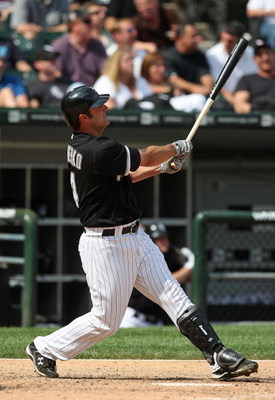 CHICAGO - JUNE 08: Paul Konerko #14 of the Chicago White Sox follows the flight of his 8th home run of the season, a solo shot in the 8th inning, against the Detroit Tigers on June 8, 2009 at U.S. Cellular Field in Chicago, Illinois. The Tigers defeated t