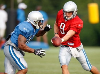 ALLEN PARK, MI - AUGUST 04:  Matthew Stafford #9 of the Detroit Lions gets ready to hand off to Kevin Smith #34 during training camp at the Detroit Lions Headquarters and Training Facility on August 4, 2009 in Allen Park, Michigan.  (Photo by Gregory Sham