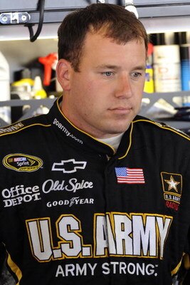 WATKINS GLEN, NY - AUGUST 07:  Ryan Newman, driver of the #39 U.S. Army Chevrolet, stands in the garage during practice for the NASCAR Sprint Cup Series Heluva Good! Sour Cream Dips at Watkins Glen International on August 7, 2009 in Watkins Glen, New York