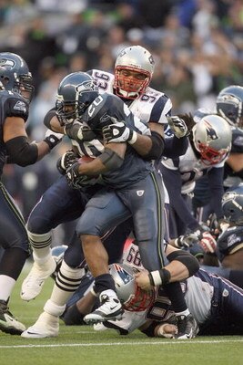 SEATTLE - DECEMBER 07:  Richard Seymour #93 of the New England Patriots tackles Maurice Morris #20 of the Seattle Seahawks during the game on December 7, 2008 at Qwest Field in Seattle, Washington. The Patriots defeated the Seahawks 24-21. (Photo by Otto 