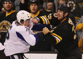 BOSTON - MARCH 31: Evgeny Artyukhin #76 of the Tampa Bay Lightning and Zdeno Chara #33 of the Boston Bruins exchange blows on March 31, 2009 at the TD Banknorth Garden in Boston. (Photo by Bruce Bennett/Getty Images)